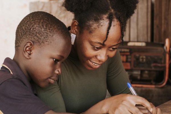 Free Photo _ Medium shot woman teaching kid to write